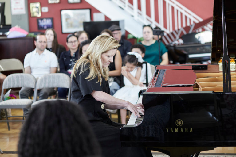 Piano teacher performing at piano recital