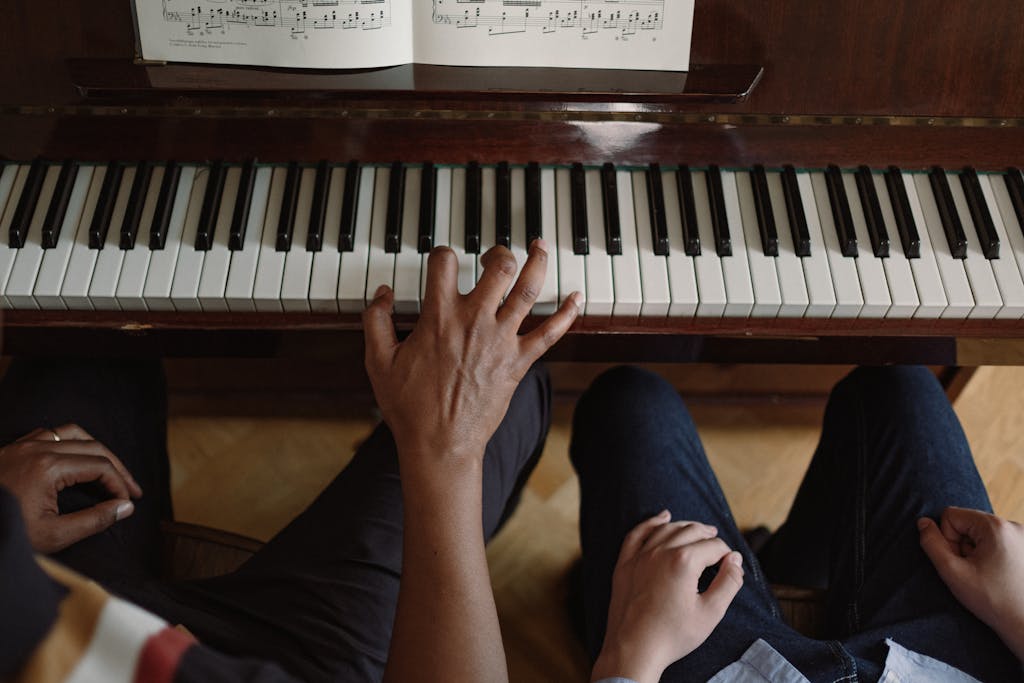 A close-up view of hands playing piano, focusing on music education and practice.