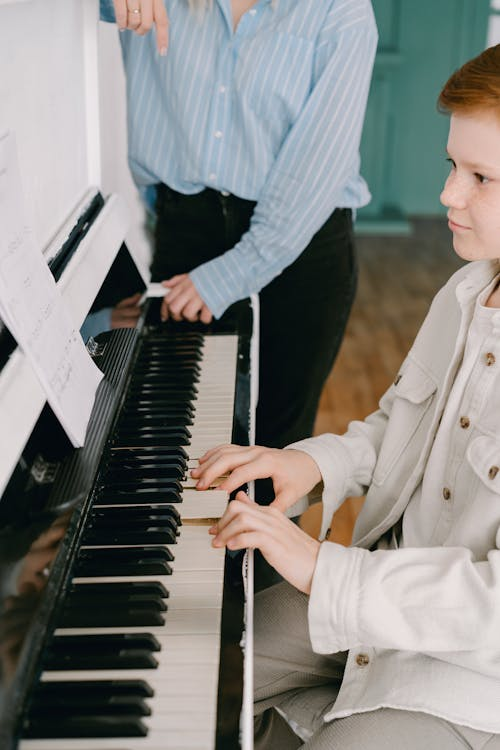 Piano teacher and student focused during lesson