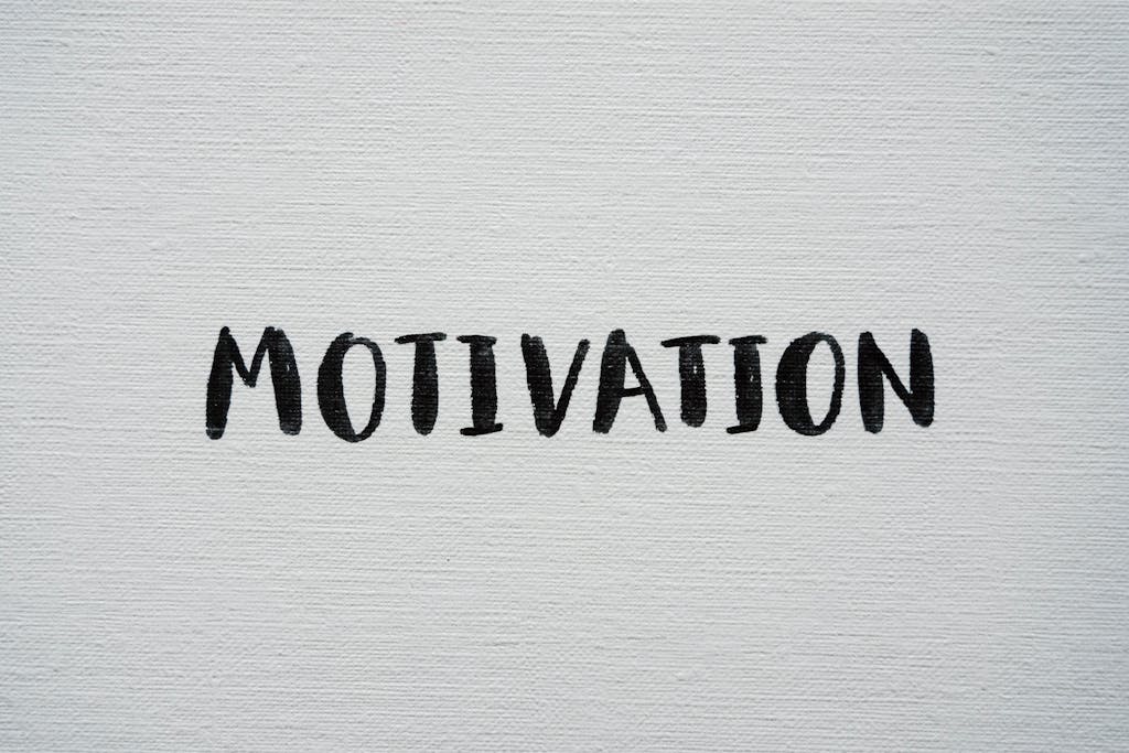 Inspirational word 'Motivation' in black on a white textured canvas background.