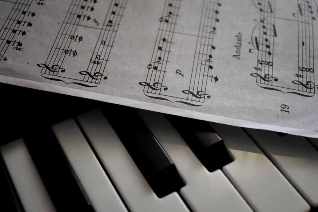 Close-up of piano keys and sheet music, illustrating what to look for when choosing a piano or keyboard for lessons