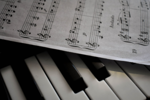 Close-up of piano keys and sheet music, illustrating what to look for when choosing a piano or keyboard for lessons