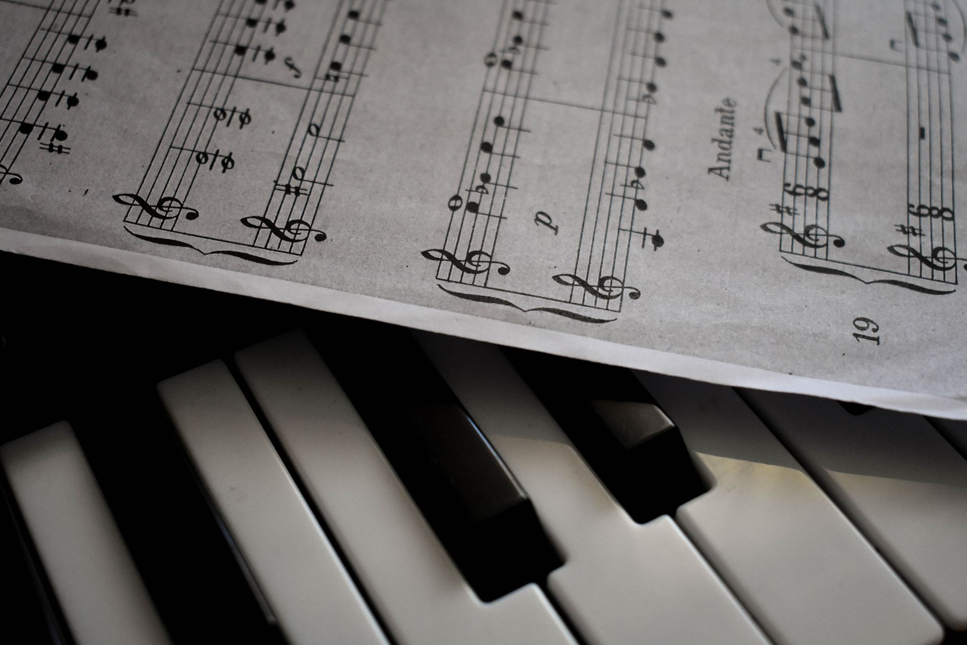 Close-up of piano keys and sheet music, illustrating what to look for when choosing a piano or keyboard for lessons