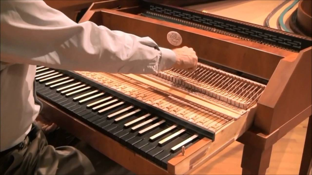 Close-up of a hand on the exposed action of an early keyboard instrument